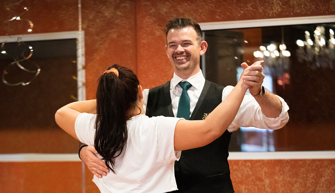 Glen Rock Ballroom teacher smiles at student during a Waltz.