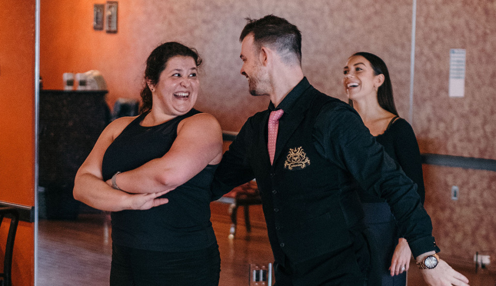 Dance Instructor and student smiling while learning choreography.