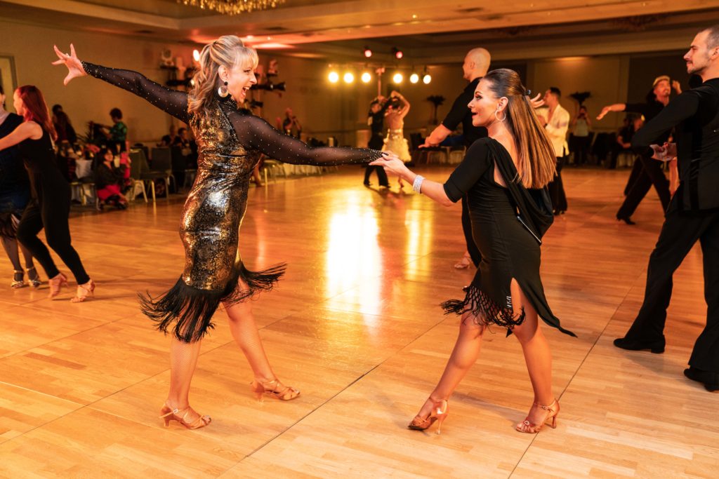 Teacher and student dance the Hustle