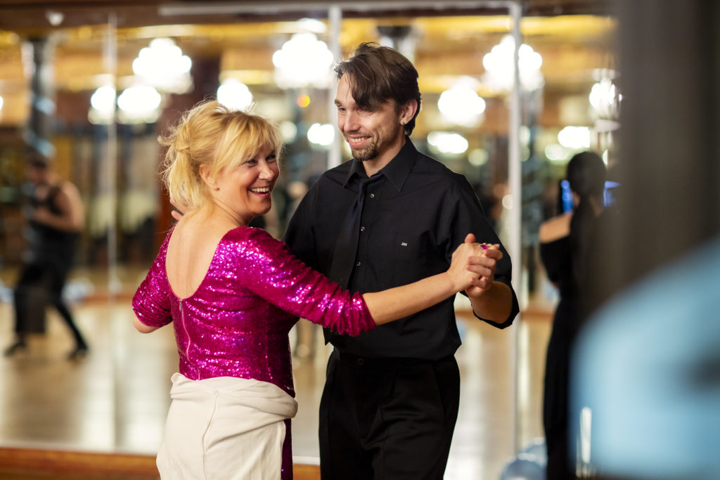 Ballroom dance student having fun at her private dance lesson