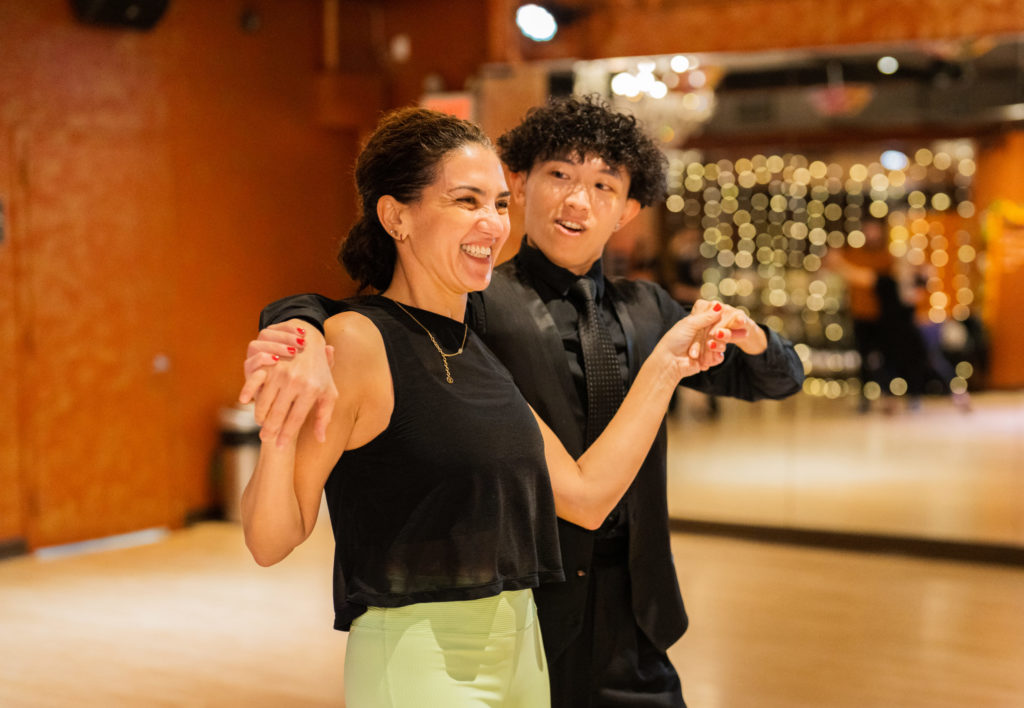 Ballroom Dance Teacher leads his student in hustle