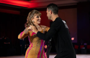 couple dancing salsa while smiling, salsa dancing, dance competition, salsa dance lessons
