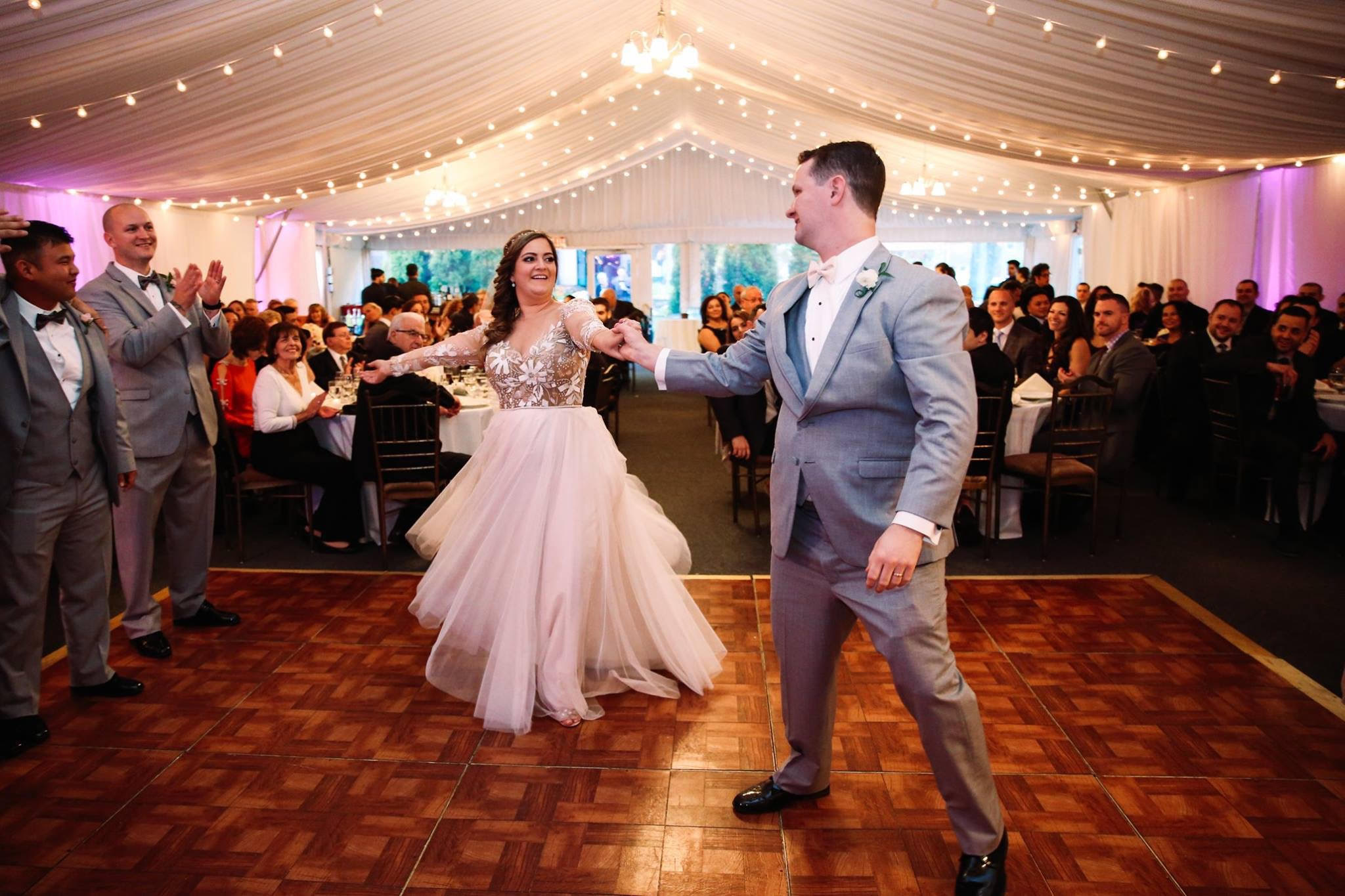 Couple rehearsing a wedding dance routine with their instructor in the studio