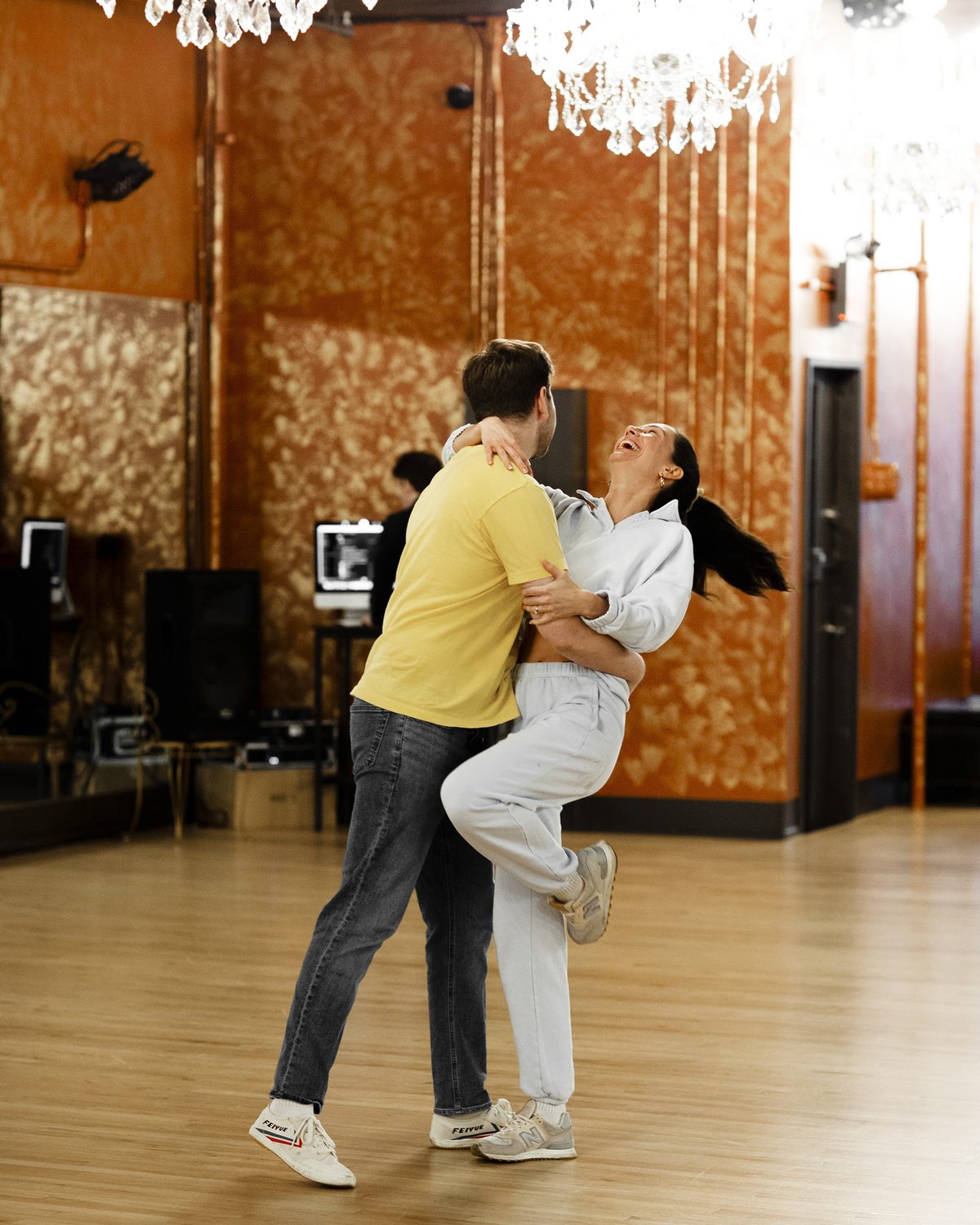 Couple practicing a bachata close hold together in a studio lesson