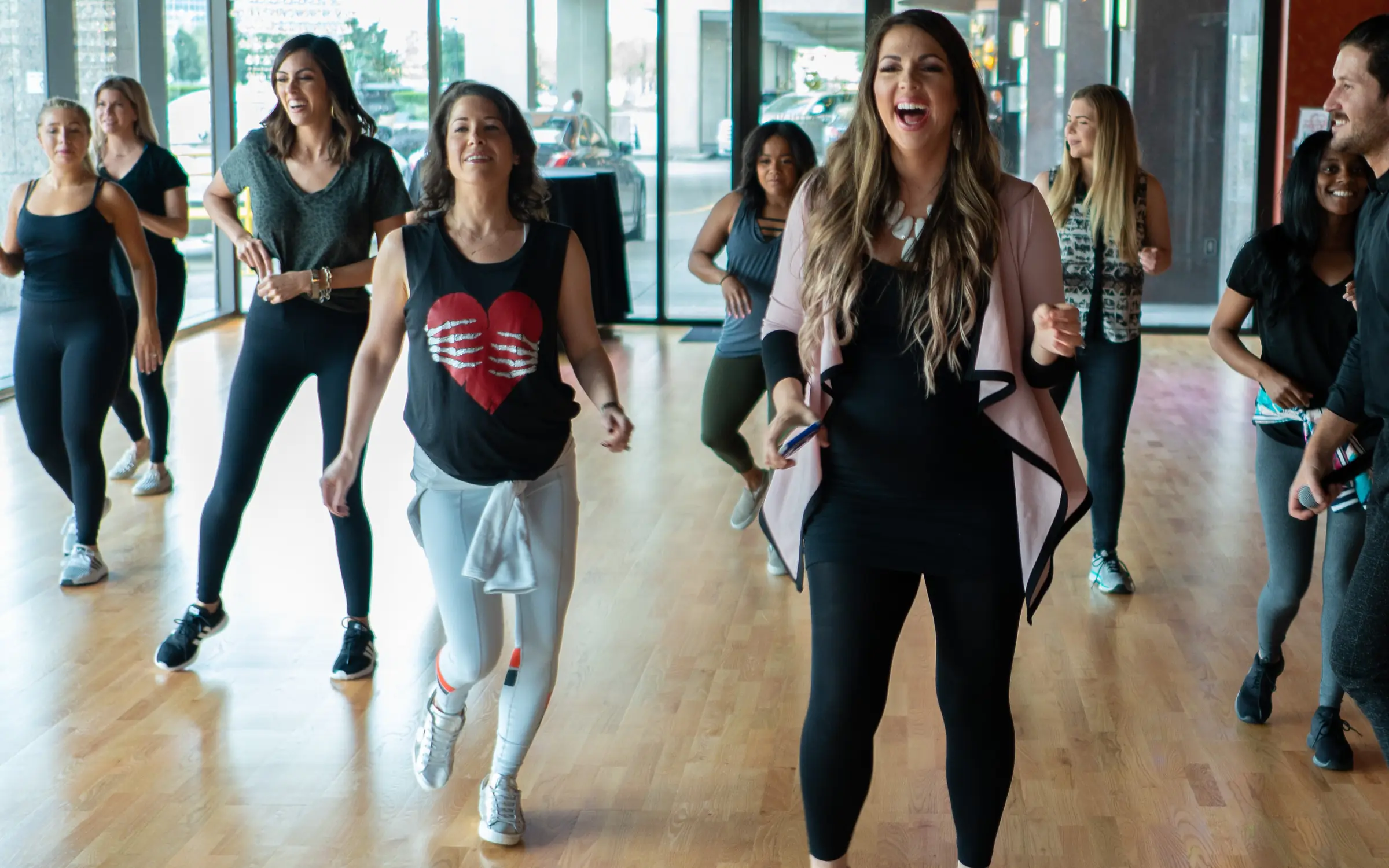 Adults laughing as they learn a dance in rows, no partners, at Dance With Me Houston